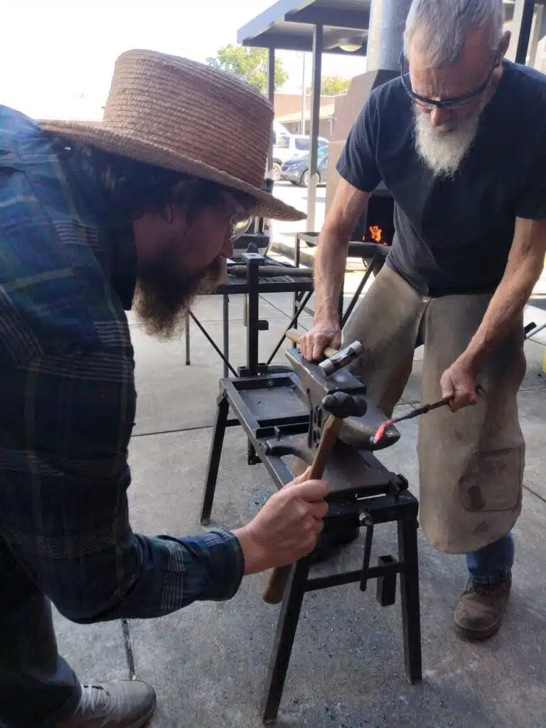 Blacksmith teaching blacksmithing at a class at the library